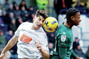 Preston North End’s Jordan Storey wins his header