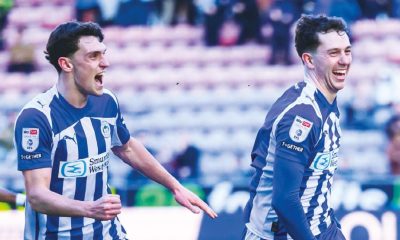 Jensen Weir celebrates scoring his crucial winner with his Wigan Athletic team-mates