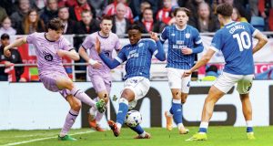 Lincoln City’s Adam Reach, left, is put under pressure by Cardiff City’s Gabriel Osho
