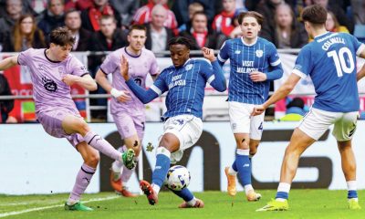 Lincoln City’s Adam Reach, left, is put under pressure by Cardiff City’s Gabriel Osho