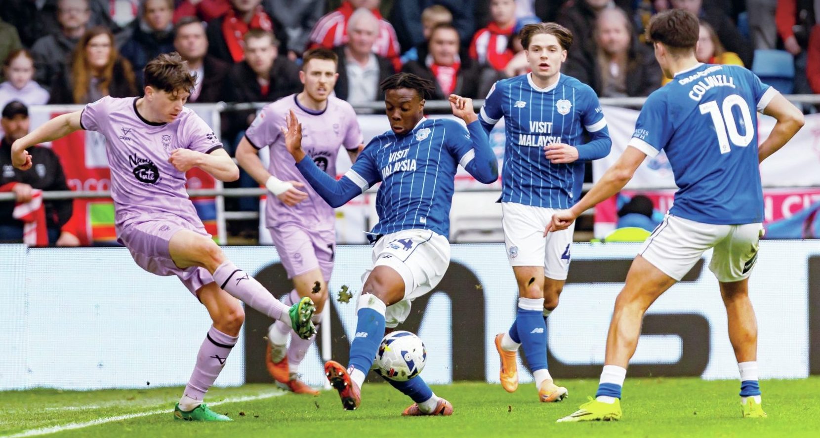 Lincoln City’s Adam Reach, left, is put under pressure by Cardiff City’s Gabriel Osho