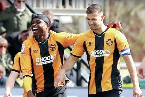 Cambridge United skipper Dominic Ball celebrates making it 1-0 with Pelly Mpanzu